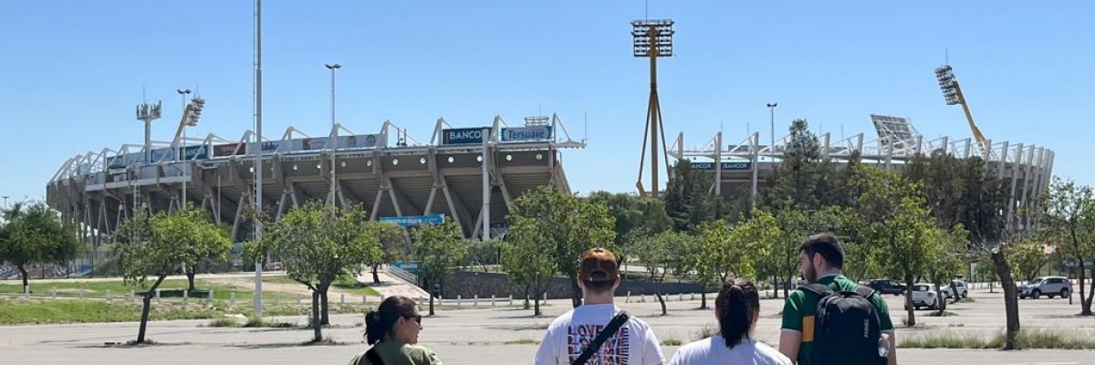 En gruppe VITA Explorers på vej mod stadion i Córdoba, Argentina, på en solrig dag – klar til en sportsaktivitet.